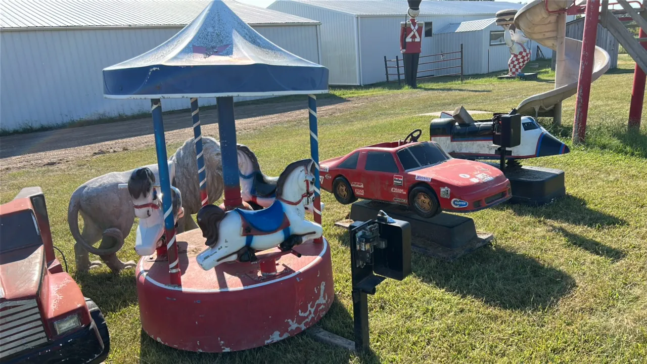 Coin-Operated Carousel with Four Horse Figures