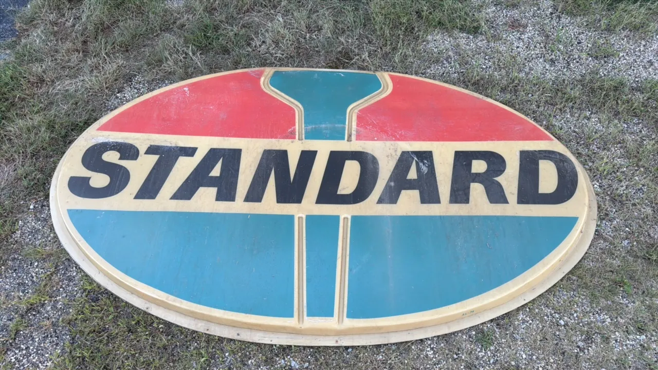 Standard Oil oval-shaped advertising sign with red, blue, and green design