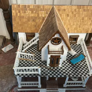 Dollhouse with Wooden Shingle Roof, Black and White Checkered Porch, and Star Gable Detail