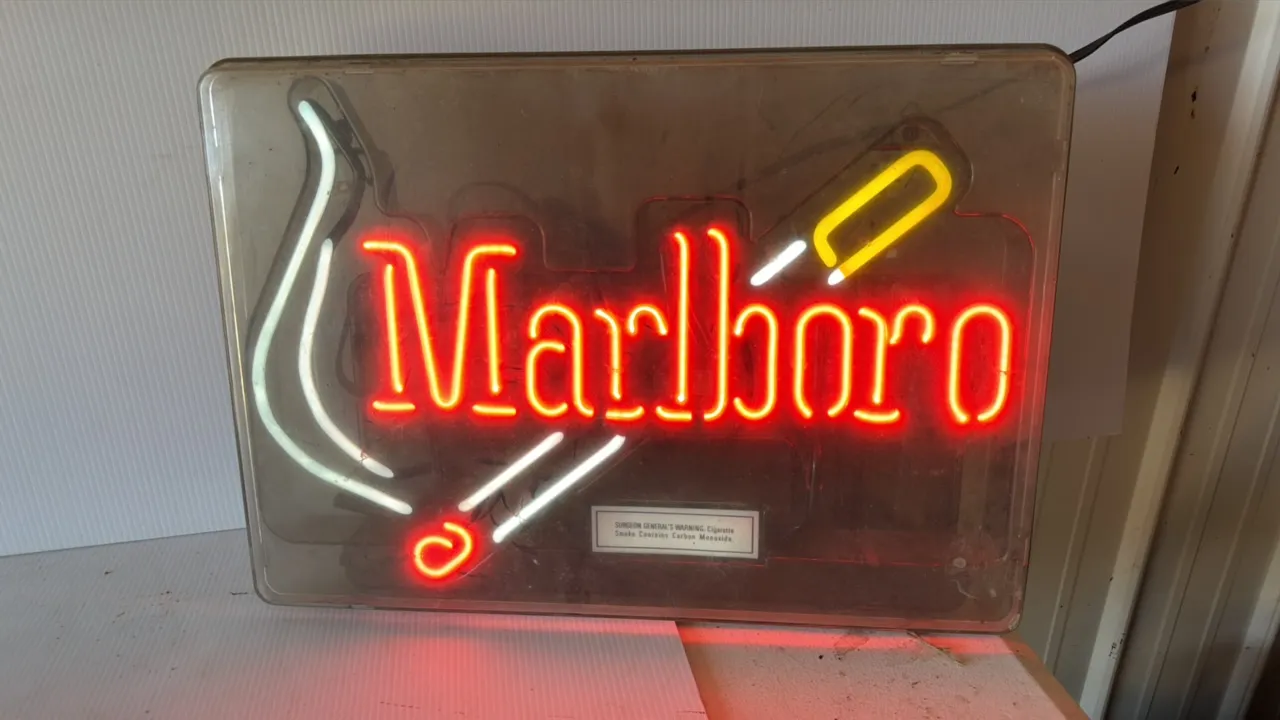 Marlboro Neon Sign with Cigarette and Smoke Motif, Surgeon General's Warning, approximately 25 inches wide