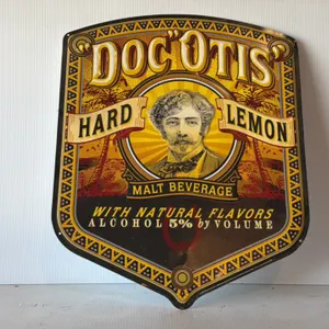2007 Doc O'Tis Hard Lemon Malt Beverage Embossed Metal Shield Advertising Sign
