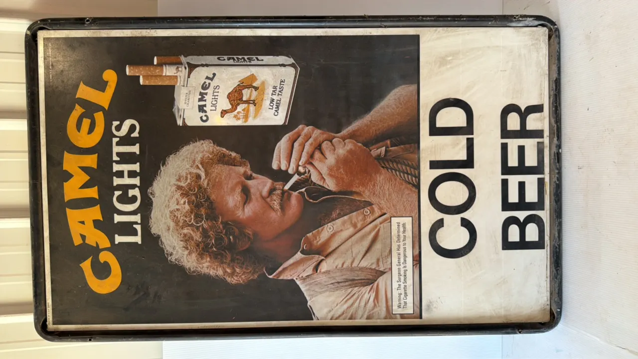 Camel Lights Advertising Sign featuring man lighting cigarette and 'COLD BEER' text