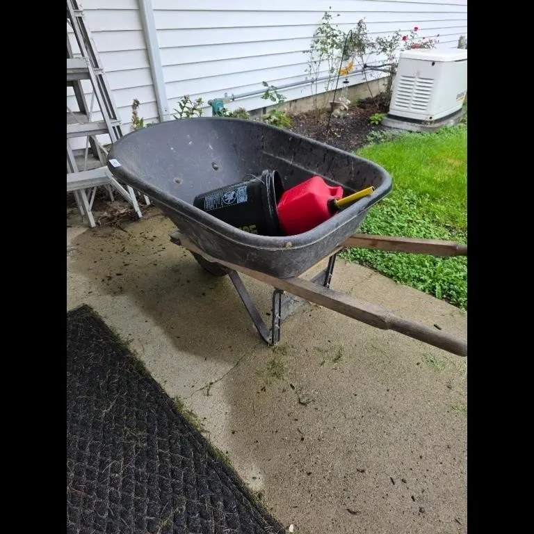 Black Wheelbarrow Set with Gas Can and Bucket Used