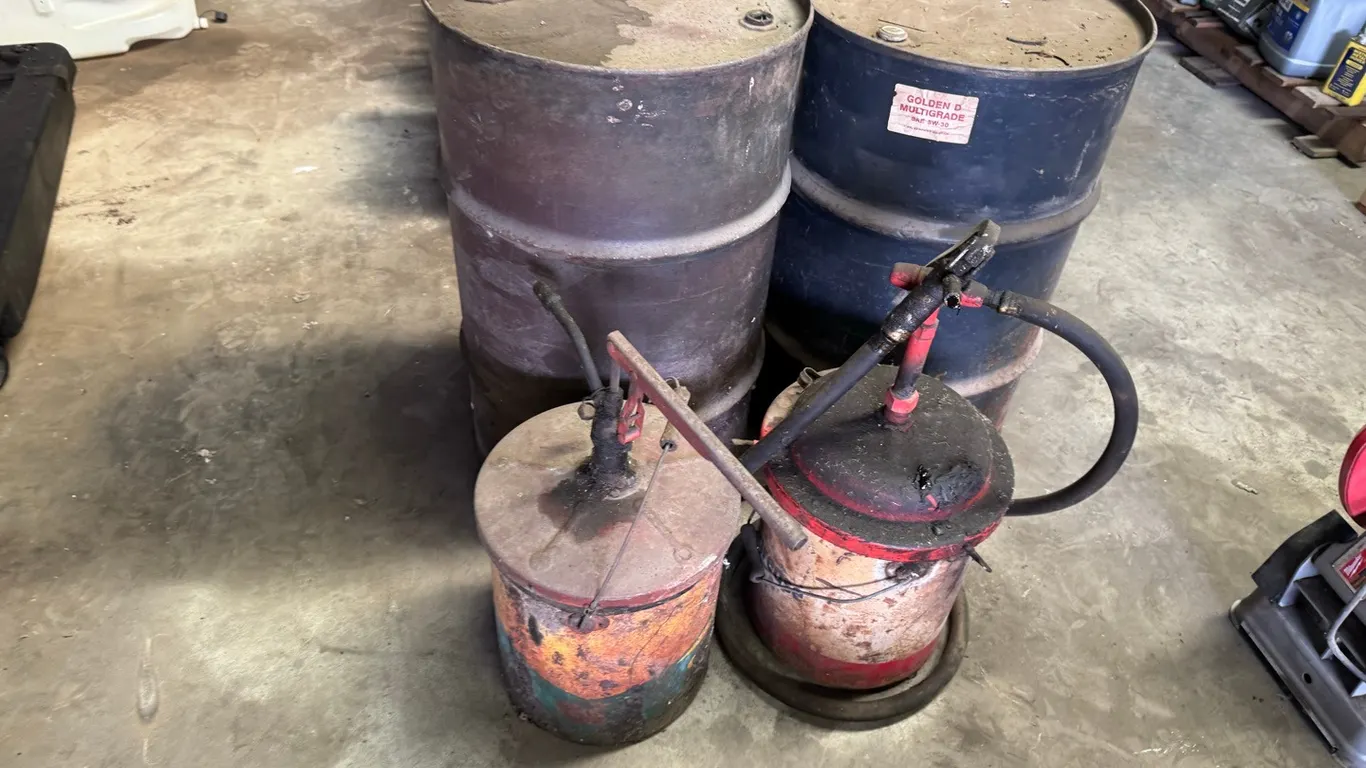 2) 50 Gallon oil barrels w/ 2) small oil pails & pumps