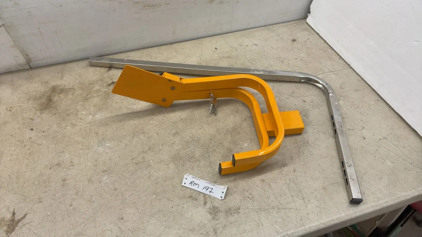 Orange Manual Folding Parking Barrier with Integrated Lock, Keys, and L-Shaped Mounting Bar