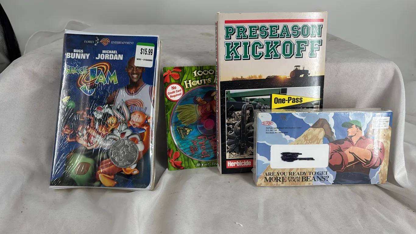 SPACE JAM VCR TAPE STILL IN WRAP AND A COIN- MISCELLANEOUS VCR TAPES
