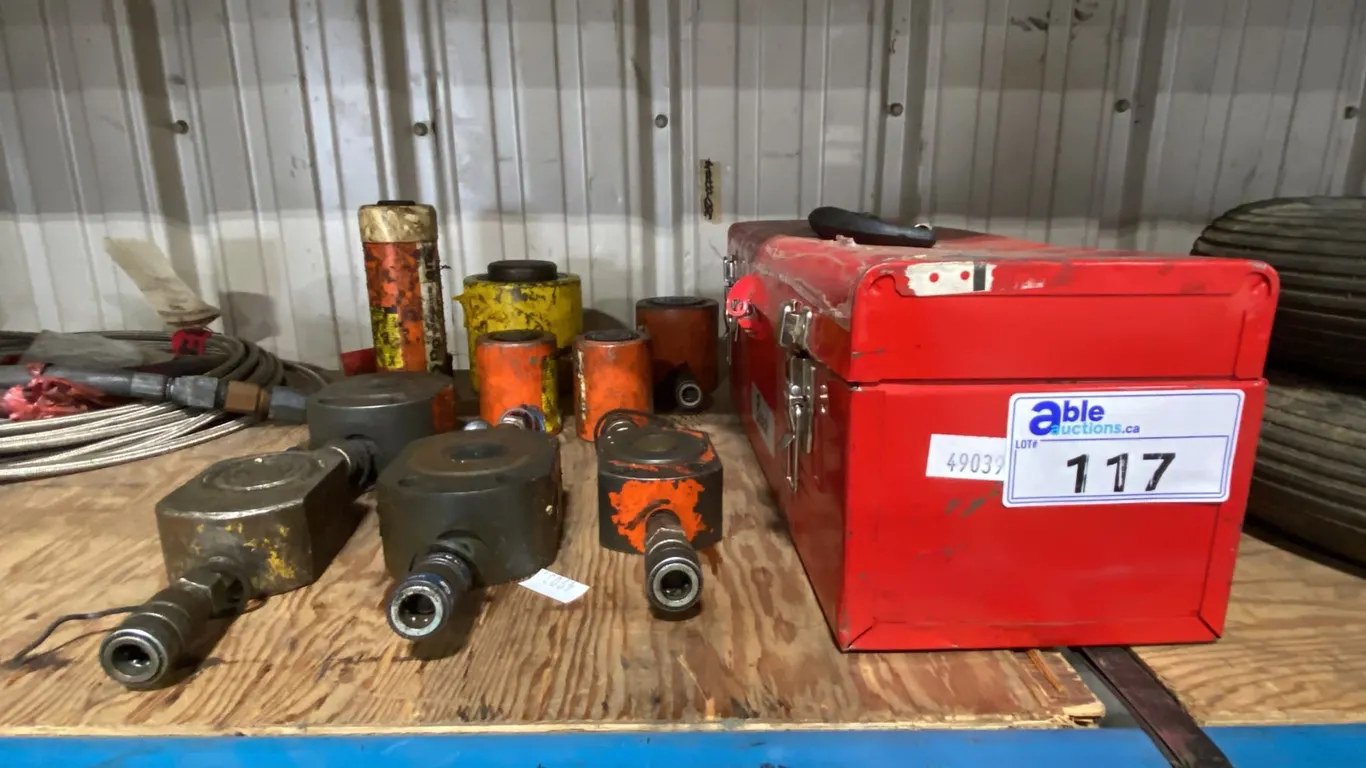 RED METAL TOOL BOX & ASSORTED HYDRAULIC RAMS