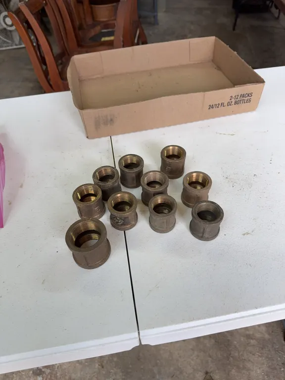 Nine brass couplers, 1 inch, 1 1/4 brass coupler
