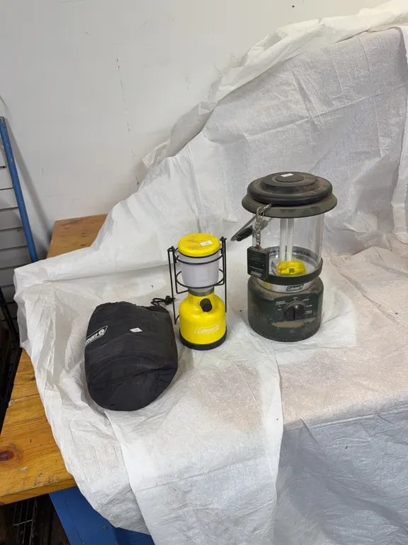 2 battery powered camping Coleman lanterns one includes a remote control
