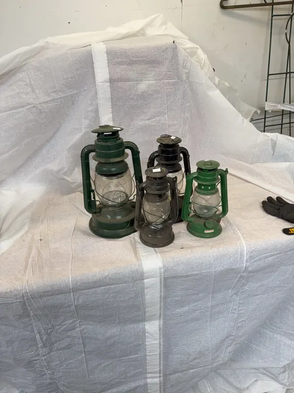 Three battery powered lanterns, one oil lantern