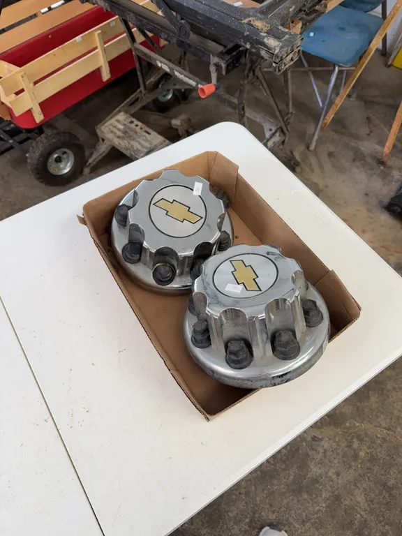 2 Chevy center caps w/lug covers