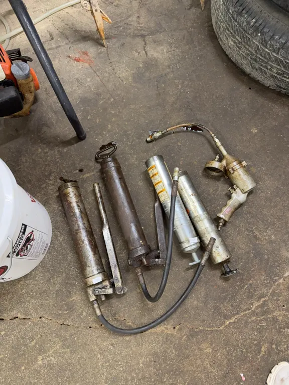 Two grease guns, grease gun parts