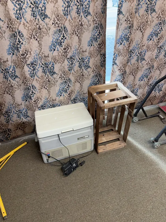 Wooden crate and a Coleman thermal electric cooler