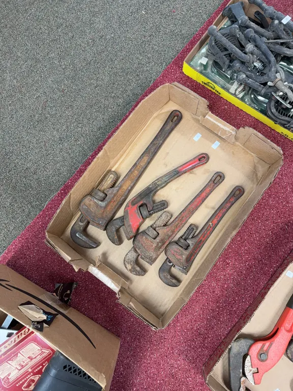 Four pipe wrenches, 14 inches and 16 inches