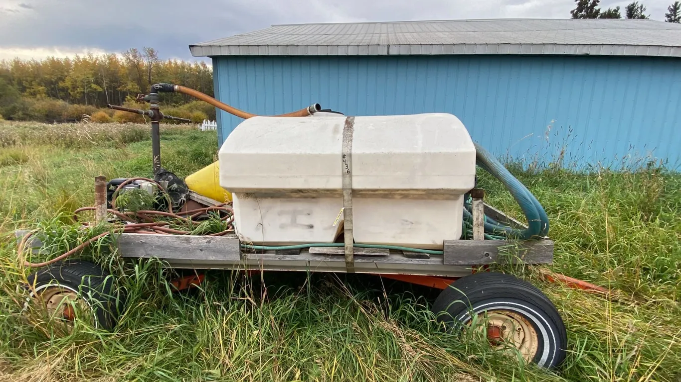 Poly tank c/w steel framed hayrack & gas water pump