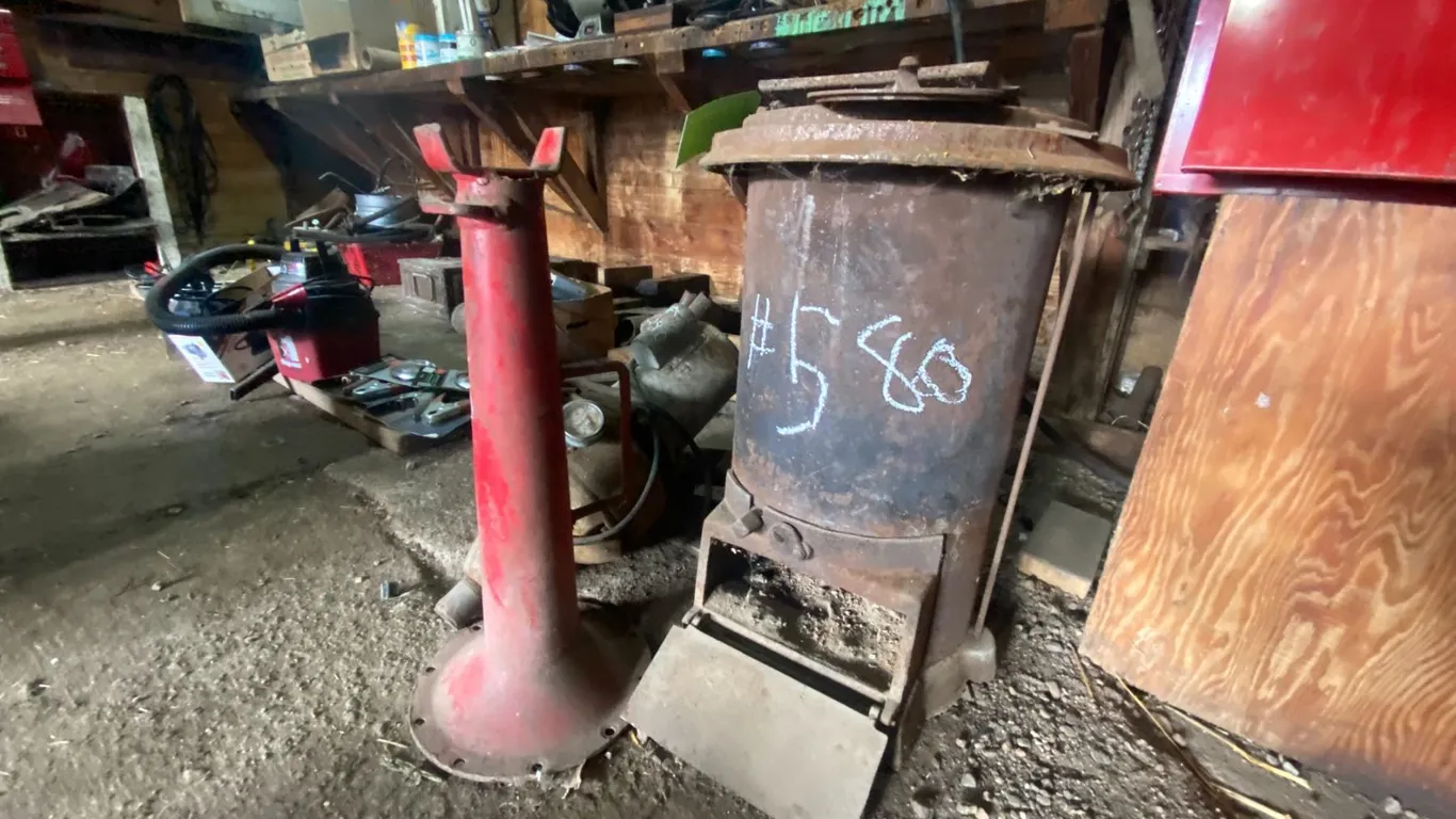 Wood heater, red stand, old water pump
