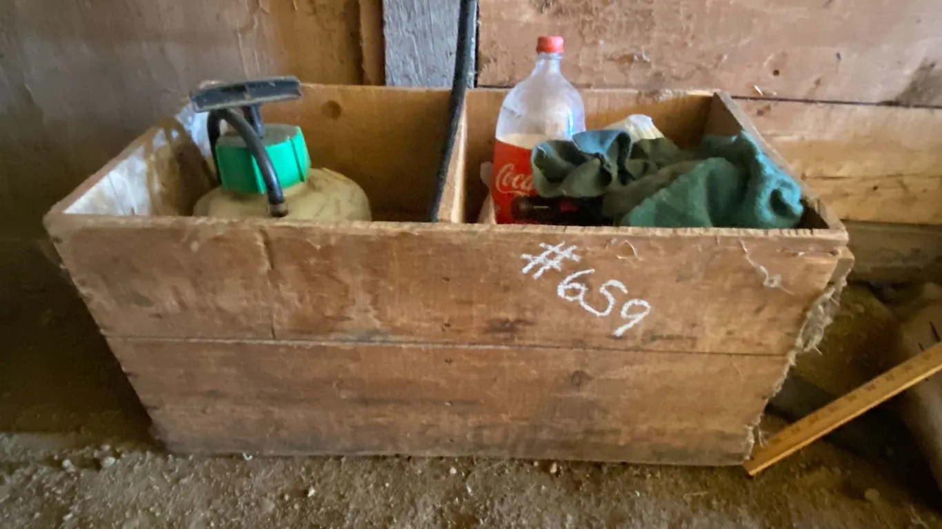 Wooden crates, yard stick, axe, auger, gas can, tank heater etc.