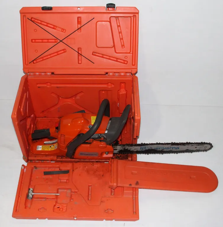 HUSQ VARNA CHAIN SAW IN A ORANGE CASE