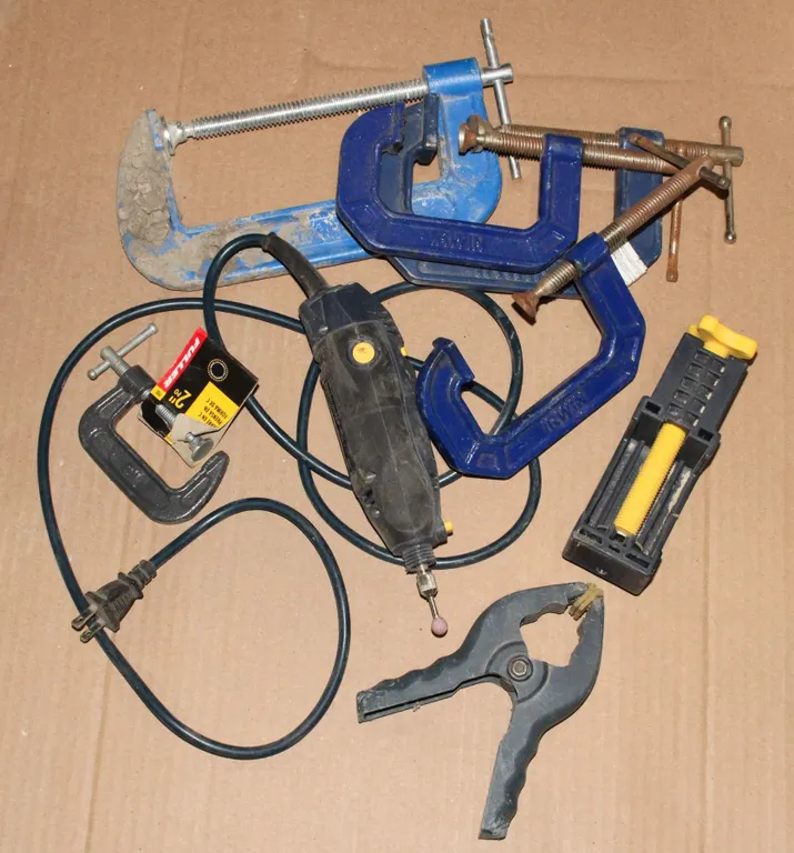 BUCKET OF ASSORTED CLAMPS AND A ROTARY TOOL
