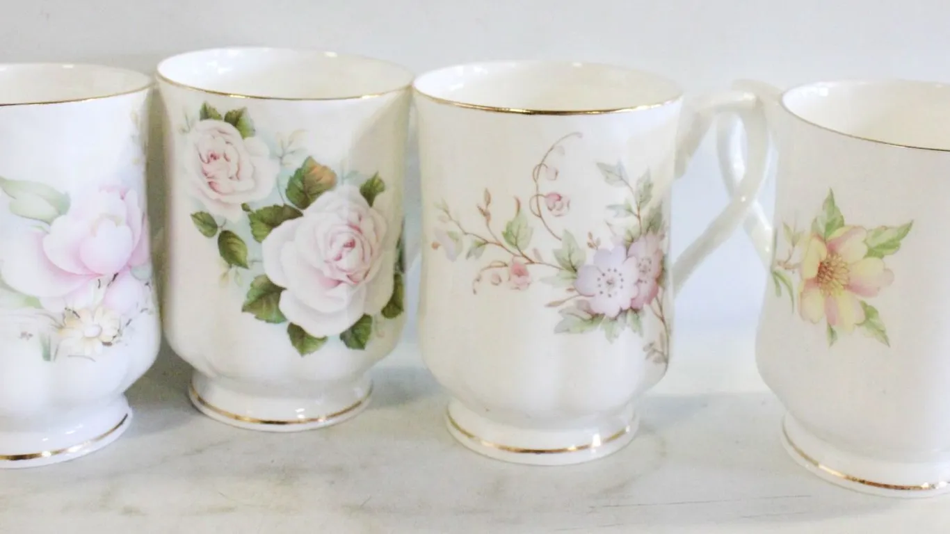 FOUR VINTAGE WHITE BONE CHINA FOOTED MUGS