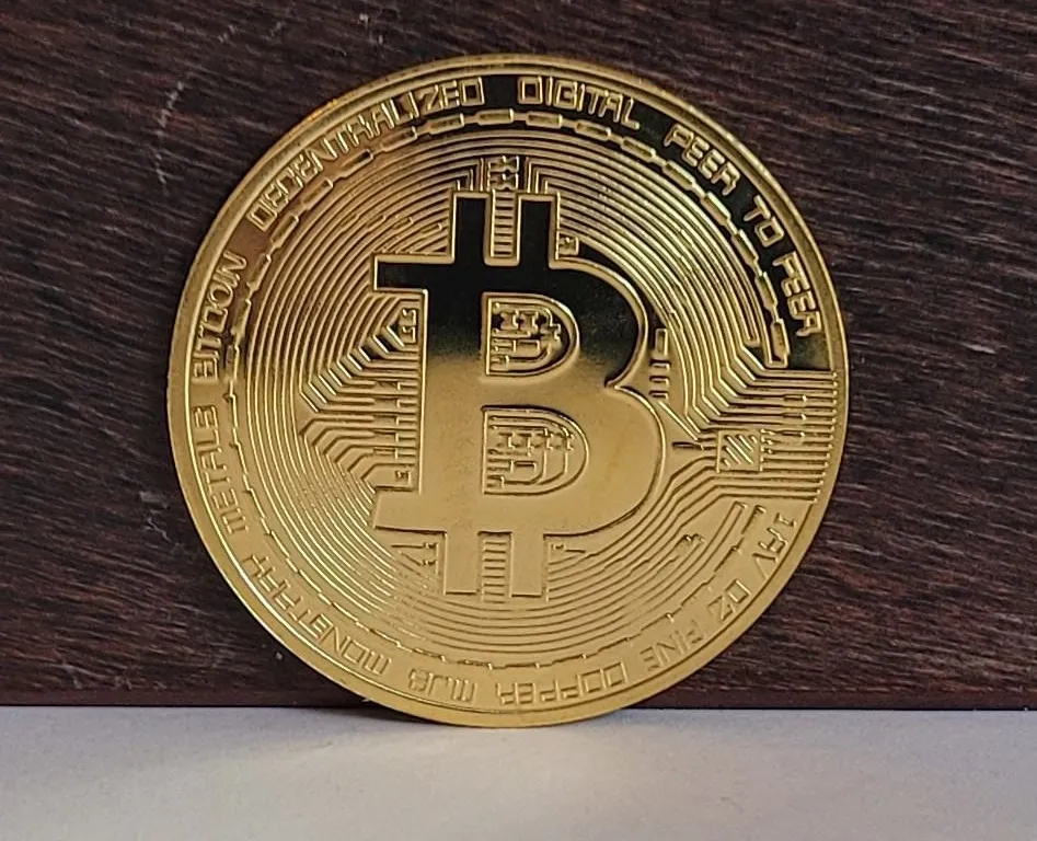12) GOLD TONE BITCOIN TOKEN.