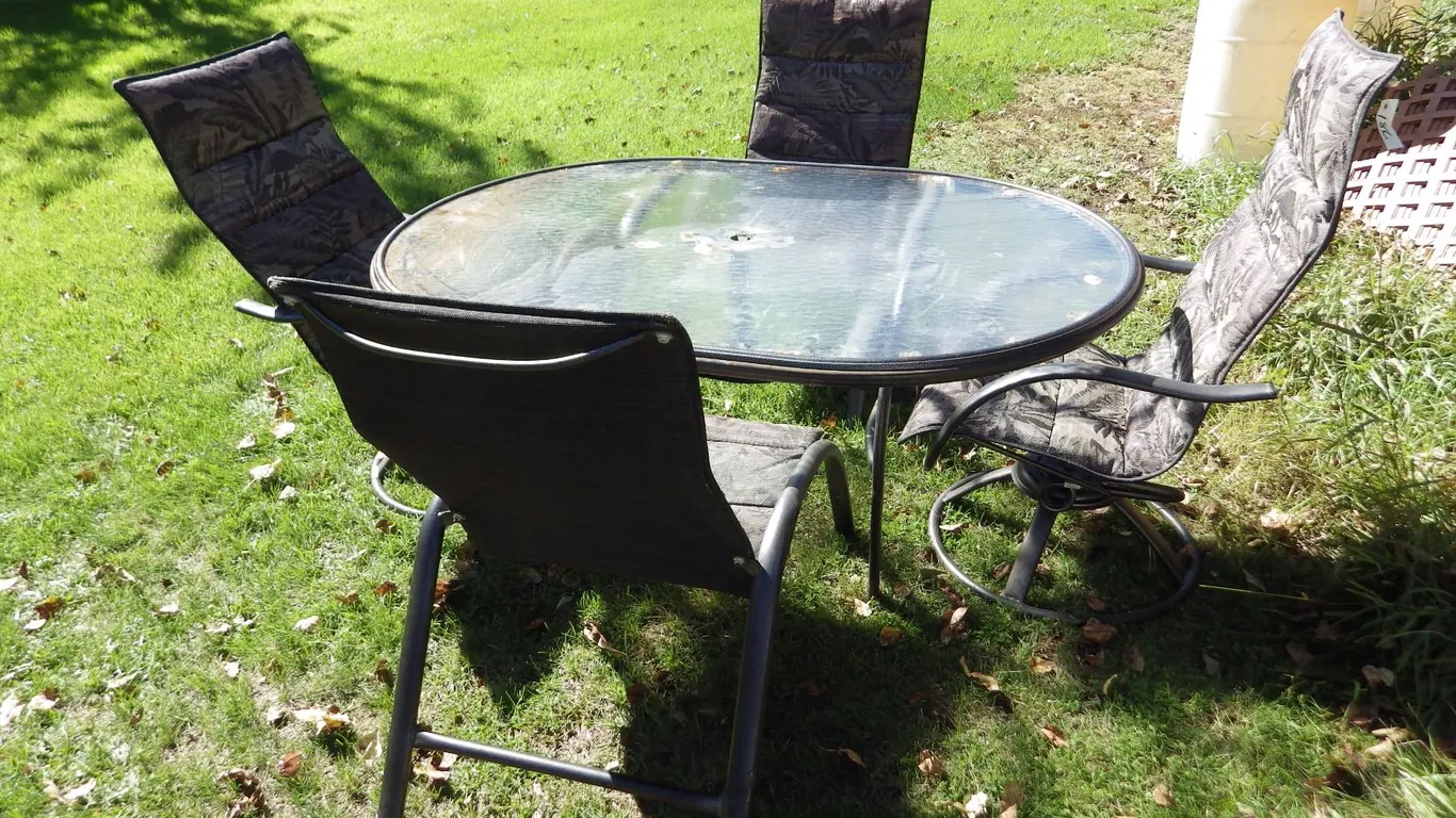 Oval glass topped patio table and 4 chairs