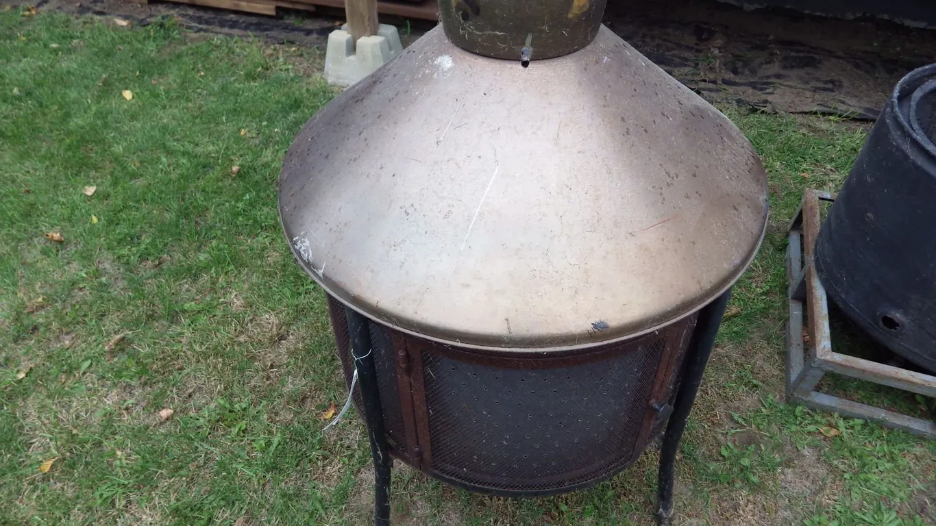 shop built lawn fire pit using dryer tub has metal topper