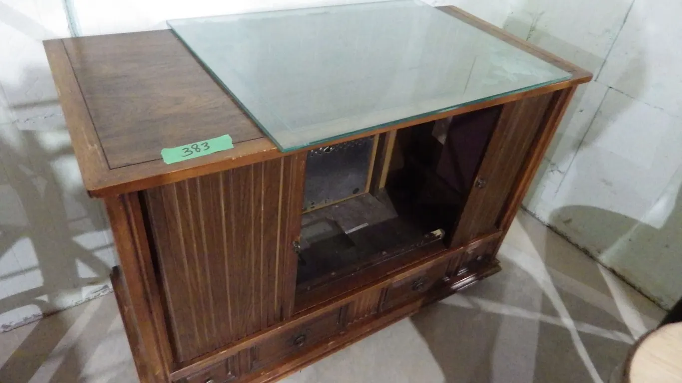 old TV converted to storage with miscellaneous Glass