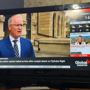 Toshiba Flat Screen TV with Remote Control Displaying Global Edmonton News Broadcast