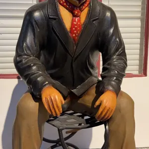 Painted Cast Iron Figure Sitting on Stool with Bowler Hat and Red Polka Dot Scarf