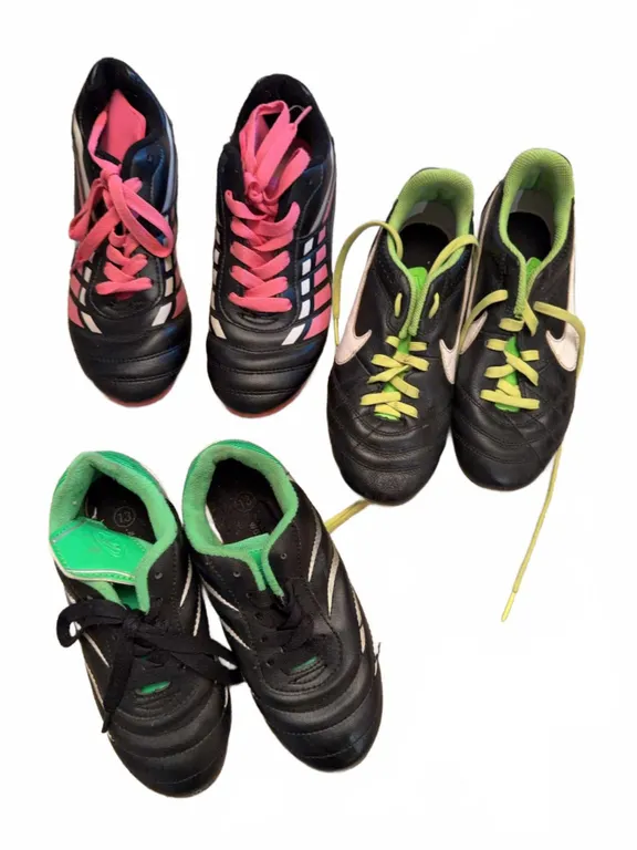 Three Pairs of Kids' Soccer Cleats Assorted Brands Sizes and Colours