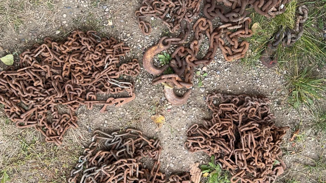 Five Piles of Heavy Rusted Metal Chains and Hooks