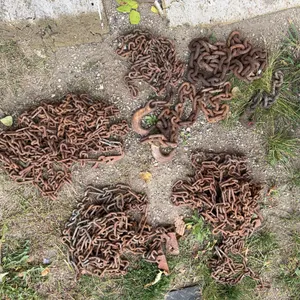 Five Piles of Heavy Rusted Metal Chains and Hooks