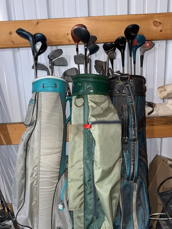 3 Golf Bags with Mixed Golf Clubs and Additional Loose Clubs