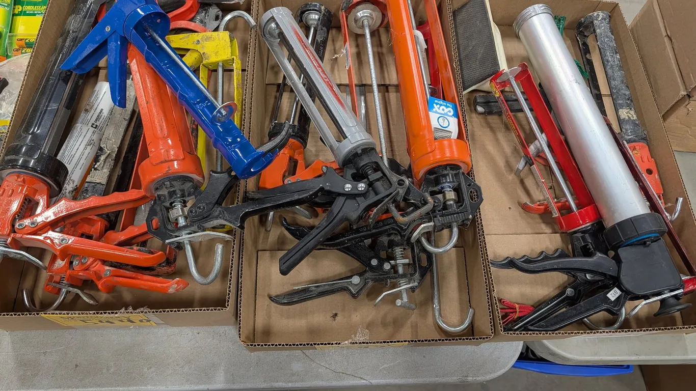 Assorted Caulking Guns And Sanding Block