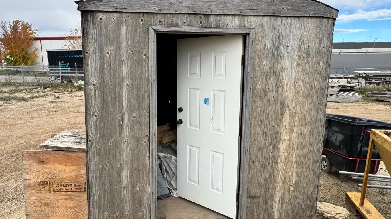 Wood-Framed Portable Storage Shed with Door, on metal rails, with interior shelving, side cabinet