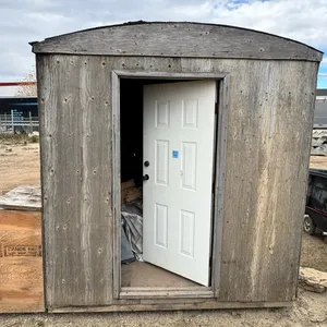 Wood-Framed Portable Storage Shed with Door, on metal rails, with interior shelving, side cabinet