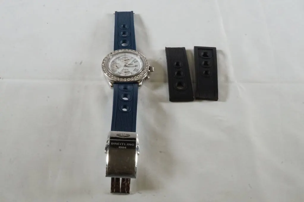 White Metal Diamond Bezel Breitling Watch w/Blue Band