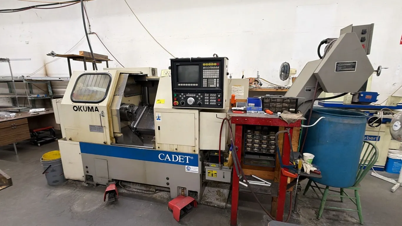 OKUMA CADET LNC-8 METAL LATHE APPROX 9FT X 5FT X 5.5FT WITH HENNIG CHIP CONVEYOR KNO-0320-00