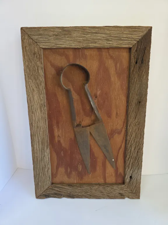Vintage pair of Metal Sheep Shears Mounted on a Weathered Wood Panel as Rustic Wall Art.