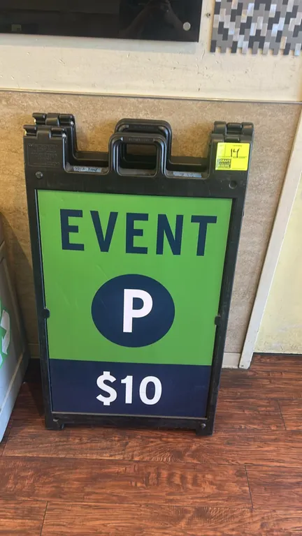 Poly collapsible sign stands. Features molded plastic A-frame construction with integrated carry handles and folding design. Fitted with 'EVENT P $10'