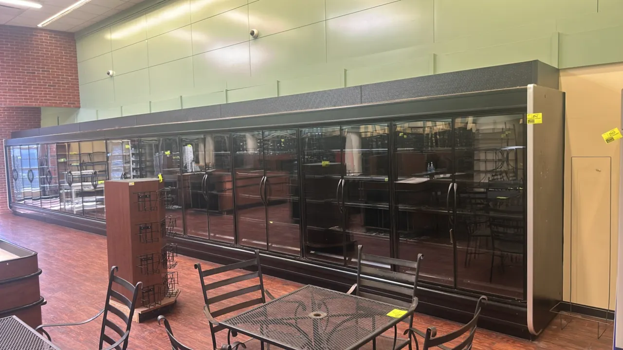 Hussmann medium-temp display cases. Features French glass display doors, solid adjustable shelving, and interior lighting. Sections include (1) 8'L an
