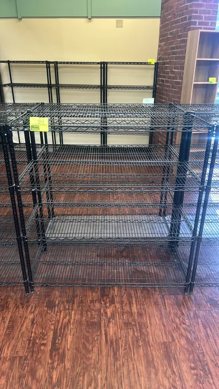 Metro multi-tier wire shelving rack. Features (5) adjustable black wire shelves. Dimensions: 48" x 20". Mounted on leveling feet.