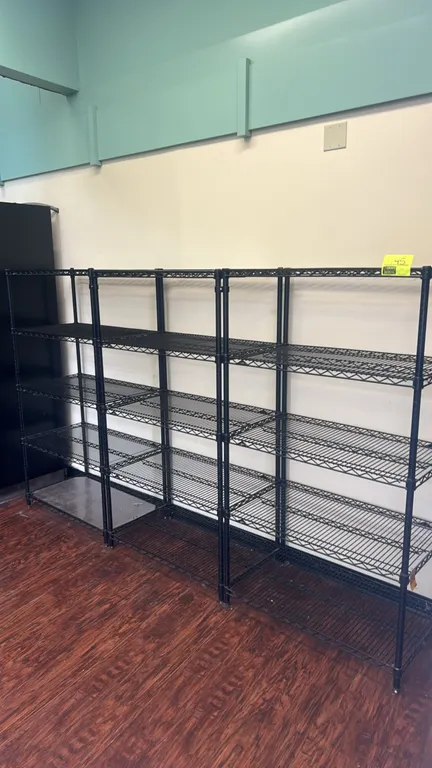 Metro wire shelving units. Features black metal wire construction with 5-tier adjustable shelves. Dimensions: 36" x 20" each. Mounted on leveling feet