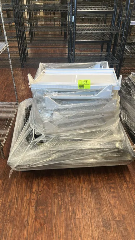 Assorted solid metal and wire shelves on pallet. Includes white painted solid metal display shelves with integrated brackets and black wire shelving.