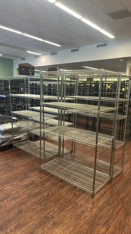 Stainless steel wire shelving racks. Includes (2) 48" x 18" racks and (2) 48" x 24" racks. Features multi-tier adjustable wire shelves on tubular post