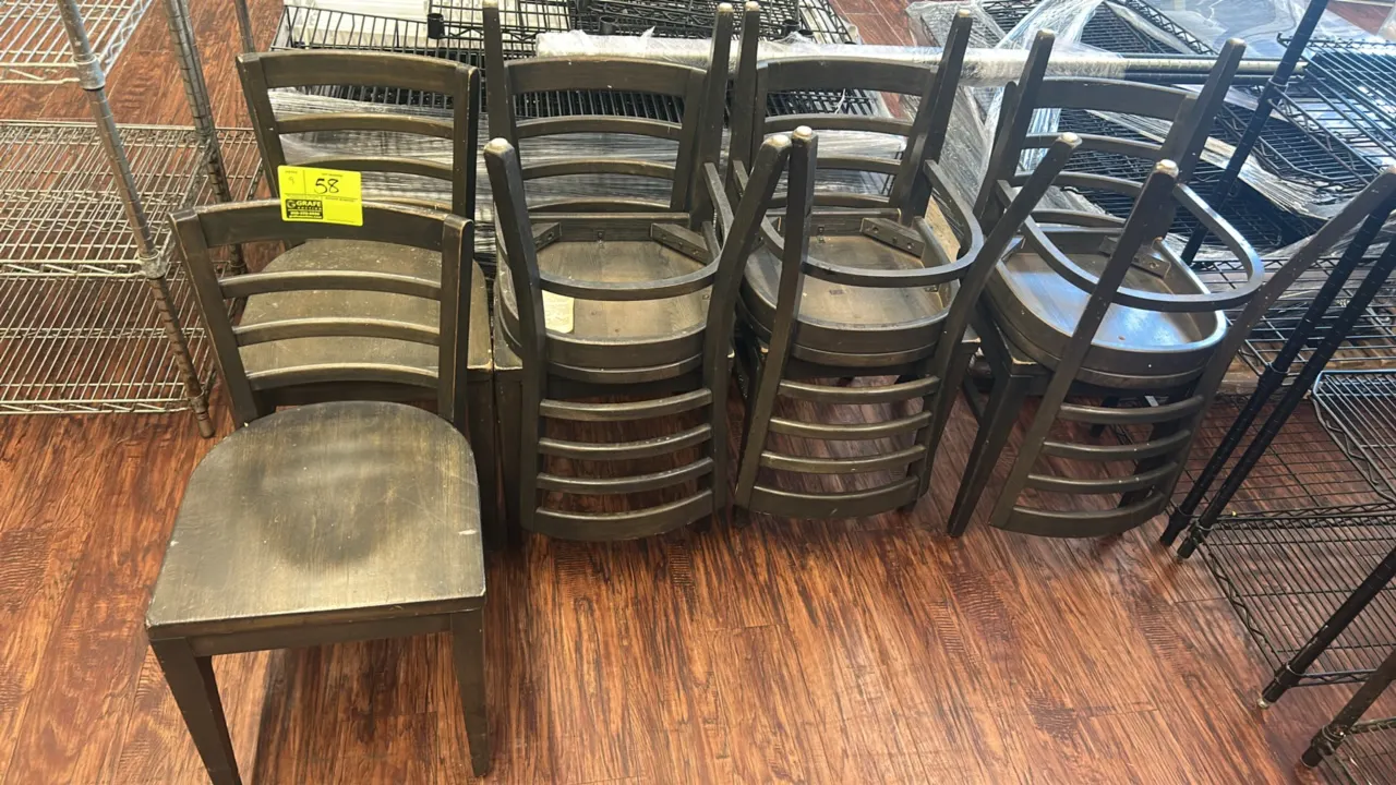 Wooden ladder-back dining chairs. Features solid wood construction with a dark finish, curved horizontal slat backs, and solid contoured wood seats.