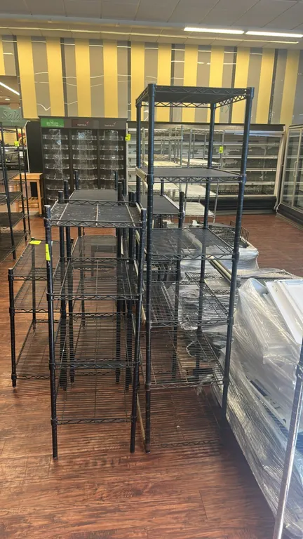Metal wire multi-tier shelving racks. Features black wire construction and adjustable wire shelves. Dimensions: 24" x 18".