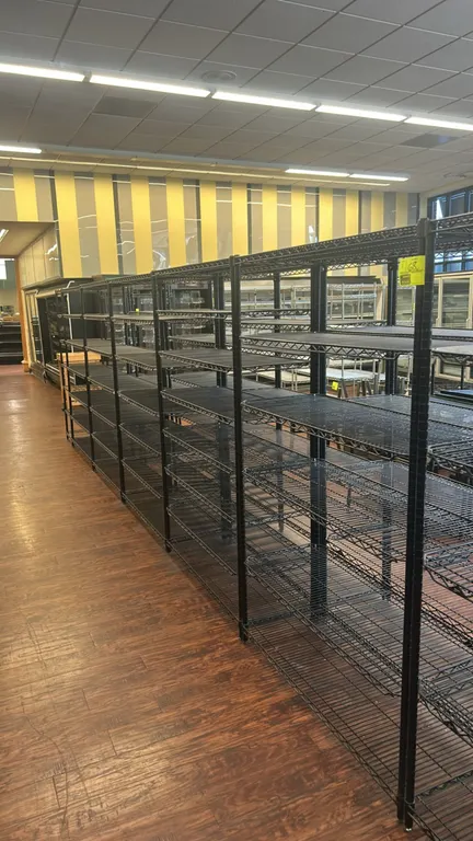 Metro metal wire multi-tier racks. Features black epoxy-coated wire construction with multi-level adjustable shelves. Dimensions: 48" x 18".