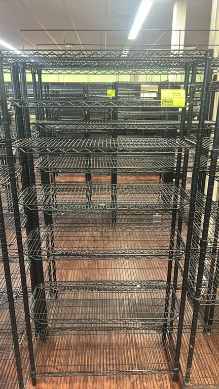 Metro metal wire multi-tier rack. Features black finish, multi-tier adjustable wire shelves, and top wire display frame. Dimensions: 36" x 18".
